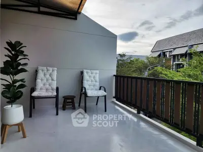 Spacious balcony with modern seating and scenic view, perfect for relaxation and outdoor enjoyment.