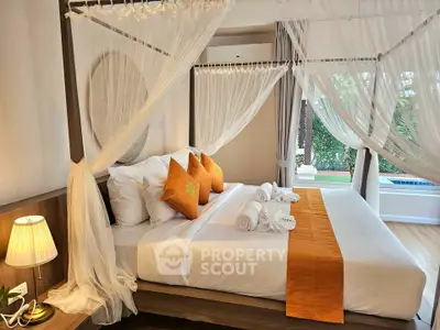 Luxurious bedroom with canopy bed and pool view in modern villa