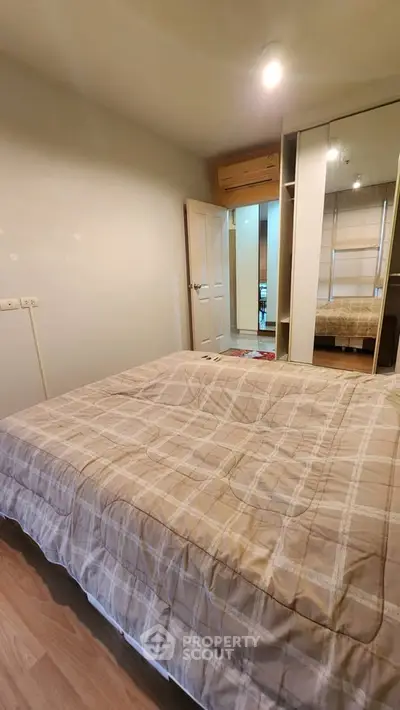 Cozy bedroom with modern decor and ample storage space, perfect for relaxation and comfort.