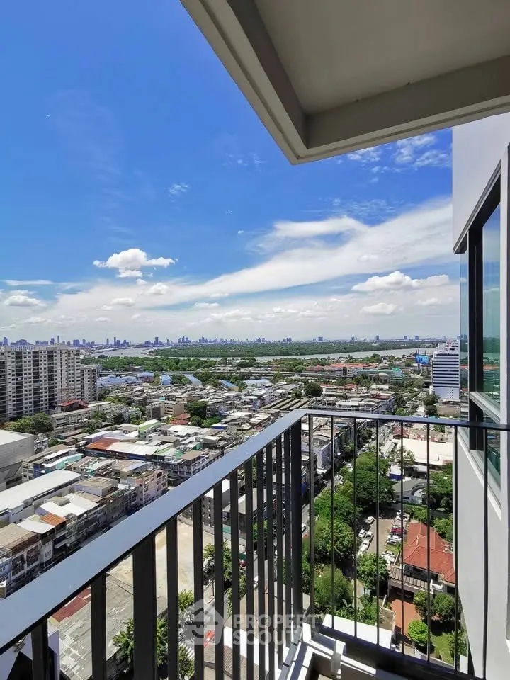 Stunning high-rise balcony view overlooking cityscape and river, perfect for urban living.