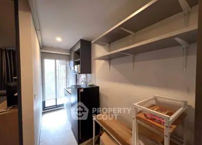 Modern kitchen with open shelving and balcony access in a cozy apartment