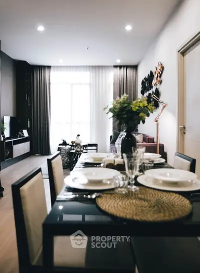 Elegant dining area leading to a cozy living room with modern decor and natural light.