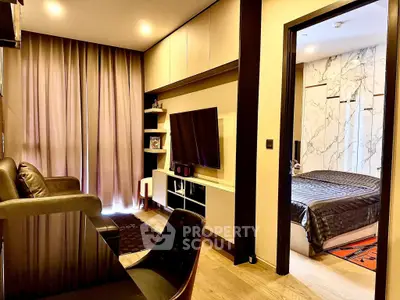 Modern living room with sleek furniture and adjacent bedroom view