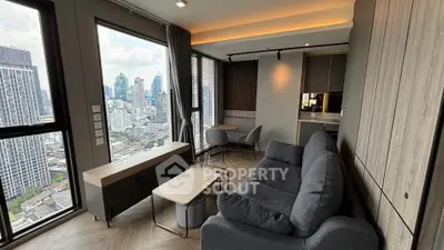 Modern living room with city view, stylish furniture, and large windows in urban apartment.