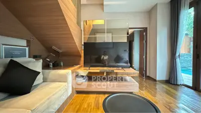 Modern living room with sleek TV setup and wooden accents