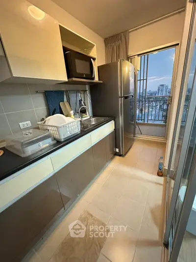 Modern kitchen with city view, featuring sleek appliances and open layout for urban living.