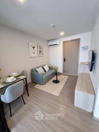 Modern living room with cozy seating and dining area in a stylish apartment.