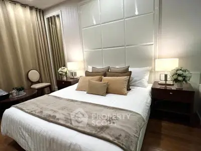 Luxurious bedroom with elegant decor and plush bedding in a modern apartment.