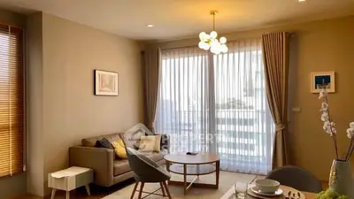 Elegant living room with modern furniture and large windows for natural light.