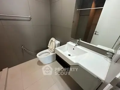 Modern bathroom with sleek fixtures and large mirror