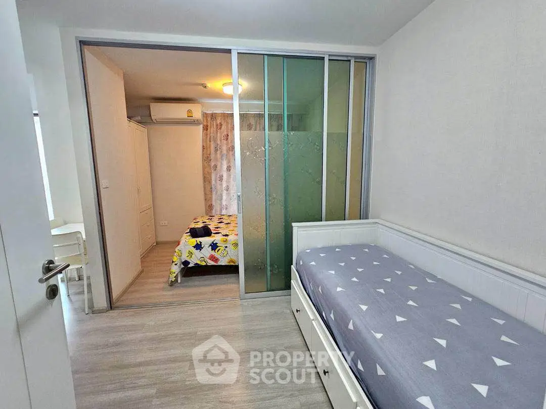 Modern bedroom with sliding glass partition and stylish decor