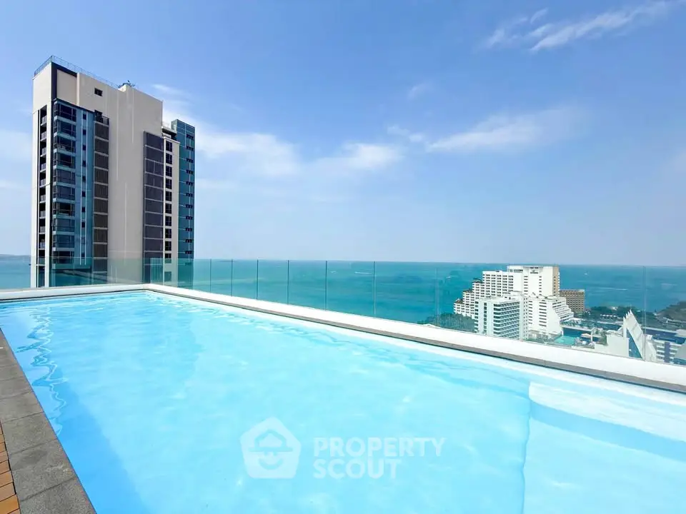 Stunning rooftop pool with breathtaking ocean view in modern high-rise building.