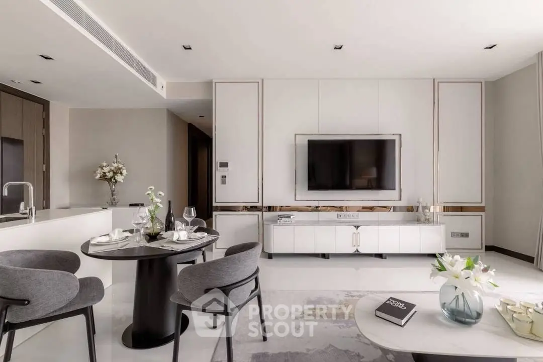 Modern living room with sleek design, featuring a wall-mounted TV, elegant dining area, and stylish decor.