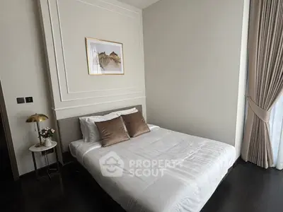 Elegant bedroom with modern decor and natural light, featuring a cozy bed and stylish accents.