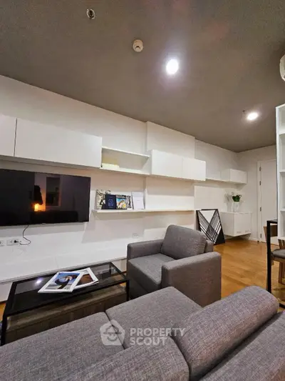 Modern living room with sleek furniture and built-in shelving, perfect for contemporary urban living.
