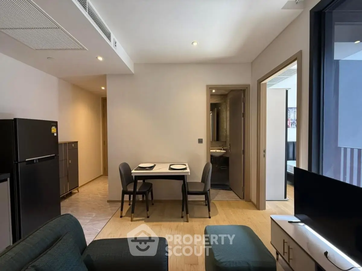 Modern apartment living room with dining area and sleek furniture