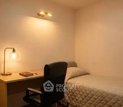 Cozy study room with single bed and desk, perfect for students or remote work.