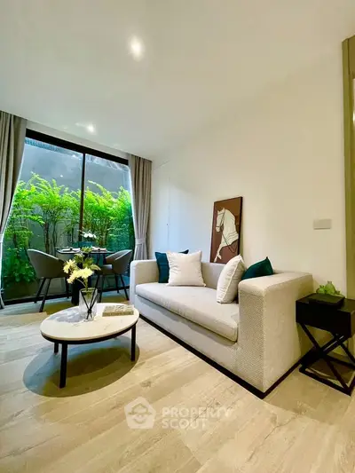 Modern living room with elegant decor and garden view, featuring a cozy sofa and stylish dining area.
