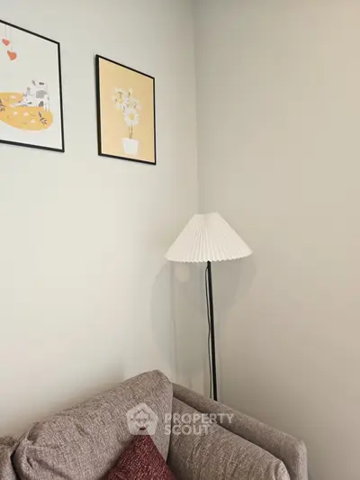 Cozy living room corner with stylish lamp and modern wall art