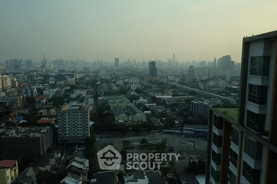 Stunning cityscape view from high-rise building showcasing urban skyline and residential areas.