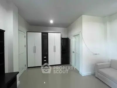 Spacious modern living room with sleek storage solutions and minimalist design.