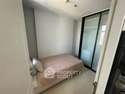 Cozy minimalist bedroom with sliding glass door and natural light