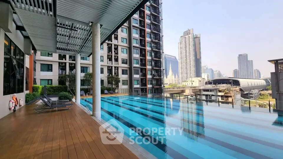 Luxurious rooftop pool with stunning cityscape views in modern high-rise building.