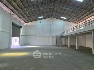 Spacious industrial warehouse with high ceilings and mezzanine level