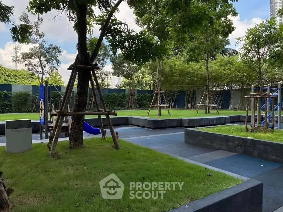 Lush green garden with playground in modern residential complex