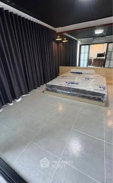 Modern bedroom with sleek design and large windows for natural light.