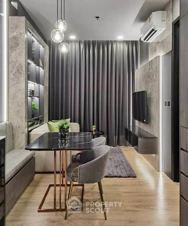 Modern living room with elegant decor, featuring a sleek dining area and stylish lighting.