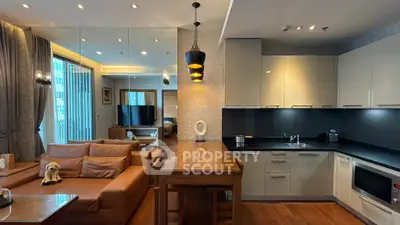 Luxurious open-layout kitchen and living room with modern furnishings and elegant lighting.