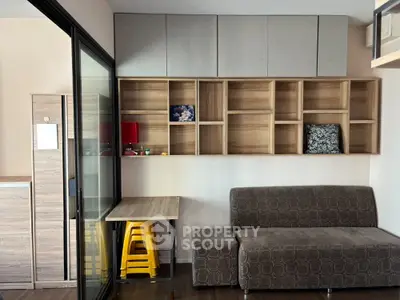 Modern living room with stylish shelving and cozy sofa in a compact space