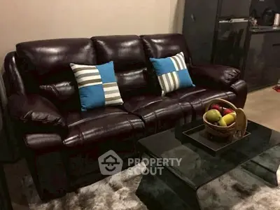 Luxurious leather sofa in modern living room with stylish decor and glass coffee table.