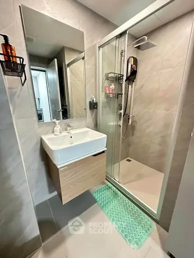 Modern bathroom with sleek shower and stylish vanity in contemporary apartment.