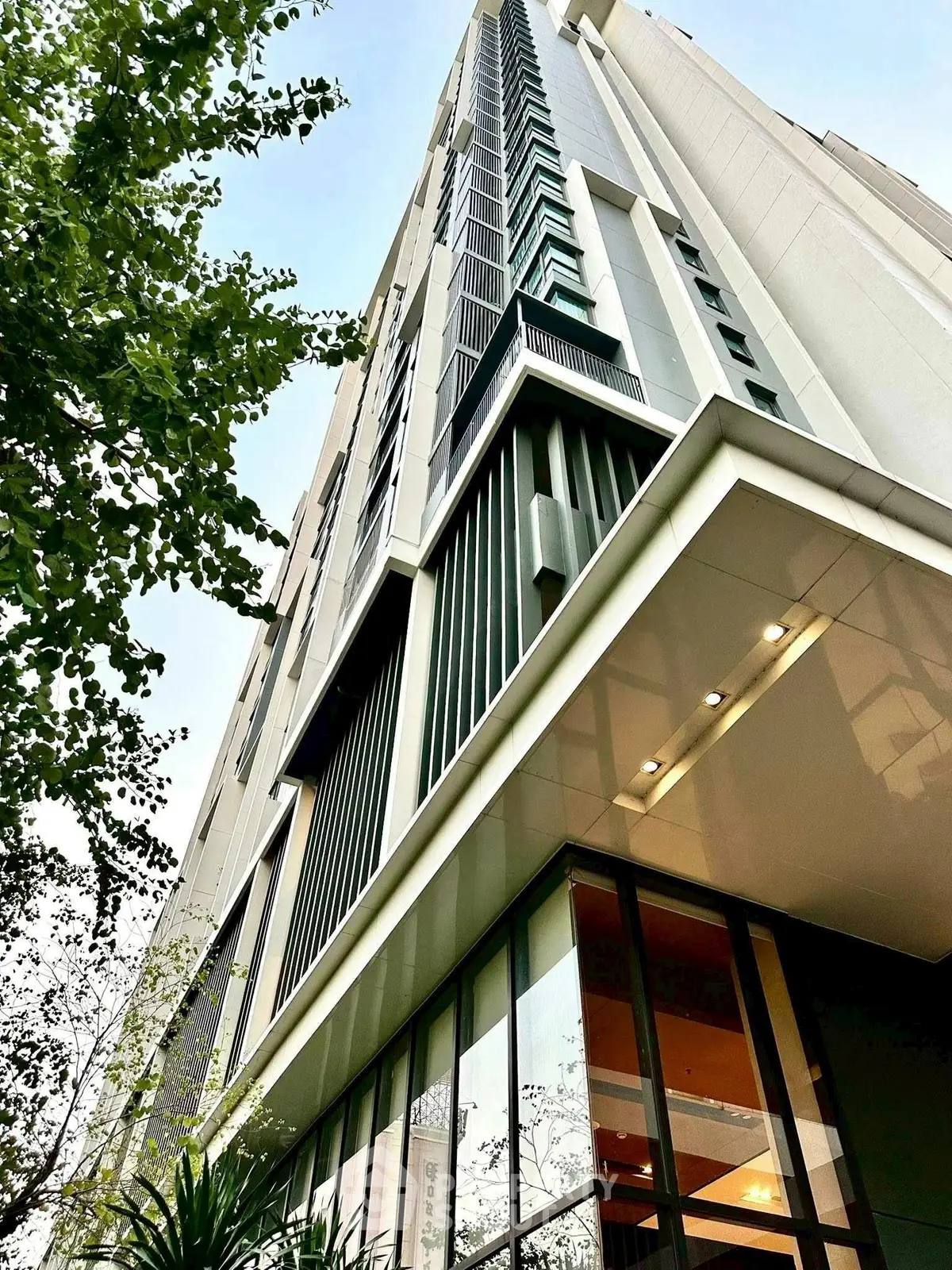 Modern high-rise building exterior with sleek architectural design and large windows.