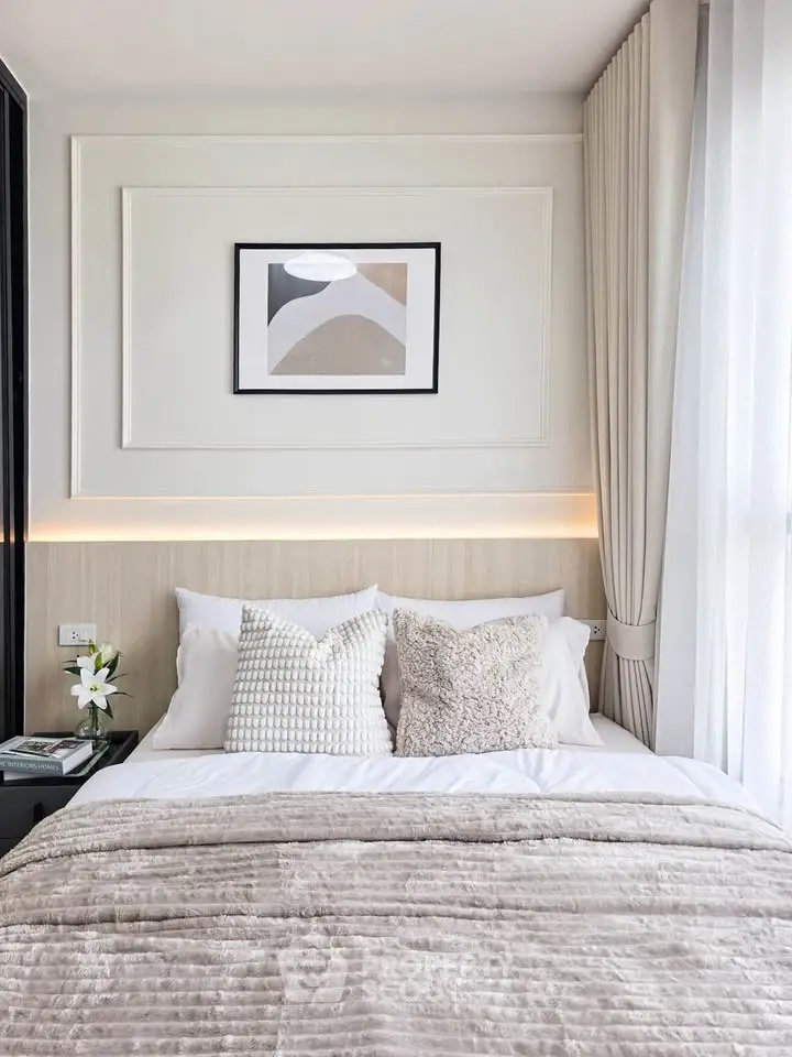 Elegant bedroom with modern decor, featuring plush pillows and soft lighting, perfect for relaxation.