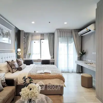 Luxurious bedroom with elegant decor, plush bedding, and natural light from large windows.