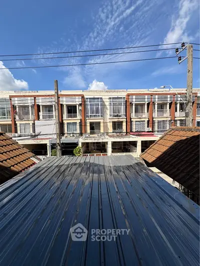 Charming townhouse view with clear blue sky and modern architecture.