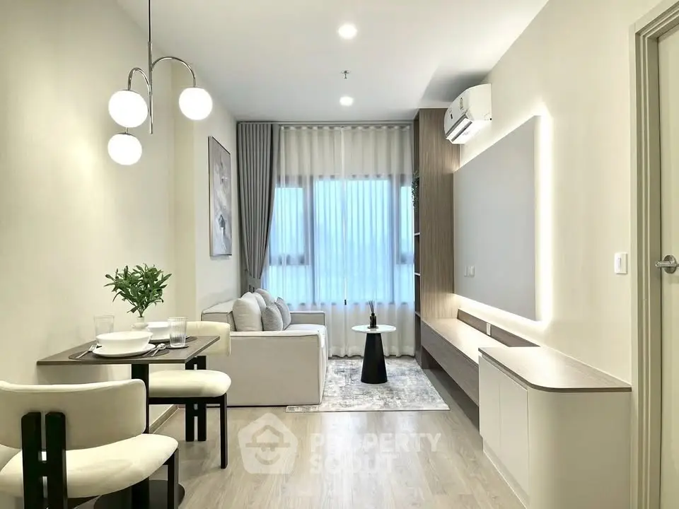 Modern living room with elegant decor, featuring a cozy sofa, stylish lighting, and a sleek air conditioning unit.