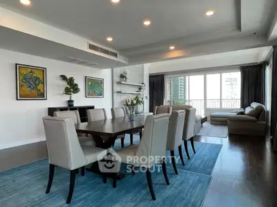 Spacious modern dining and living area with elegant decor and large windows.