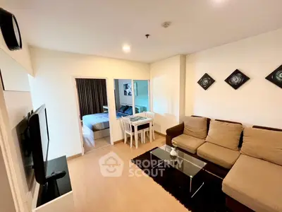 Modern living room with cozy sofa and stylish decor, adjacent to a bedroom, ideal for urban living.
