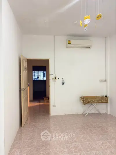 Cozy interior room with air conditioning and tiled flooring, perfect for a comfortable living space.