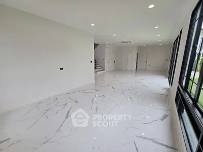 Spacious modern living room with marble flooring and large windows