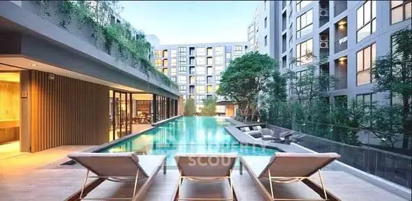 Luxurious apartment complex with stunning pool and modern architecture.