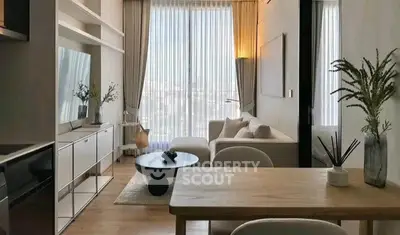 Modern living room with stylish decor and large window offering city views.