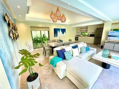 Luxurious open-plan living room with modern decor and elegant dining area, perfect for entertaining.