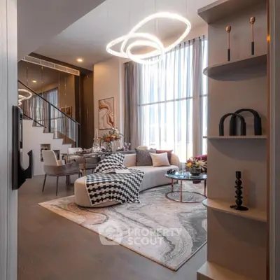 Luxurious modern living room with elegant decor and high ceilings in a stylish apartment.
