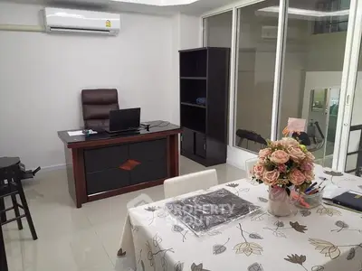 Modern home office with elegant desk and floral centerpiece