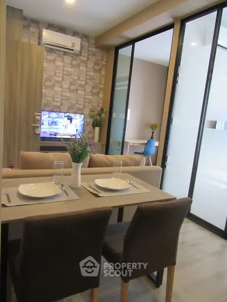 Modern living room with dining area and stylish decor in a cozy apartment.